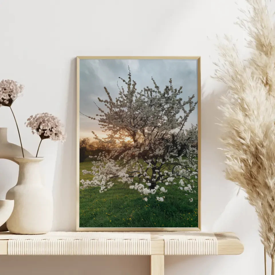 Poster blühender Baum auf grüner Wiese mit gelben Blumen für dein Zuhause