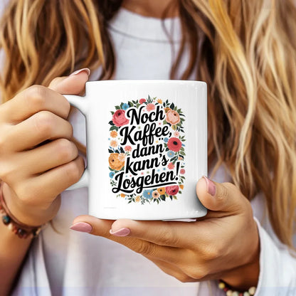 Lustige Tasse mit Blumen und Spruch Noch Kaffee dann kanns losgehen